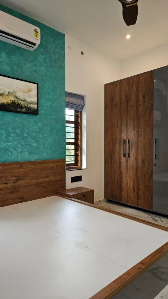 Bedroom with a teal feature wall, timber platform bed and wardrobe