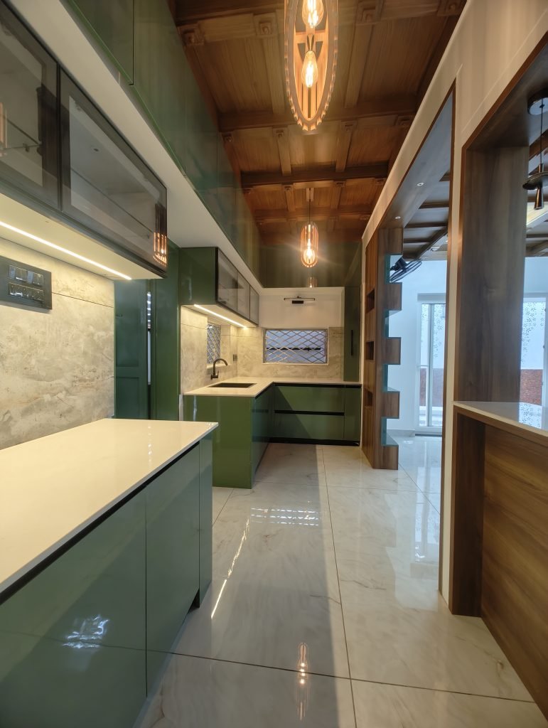 Green kitchen cabinetry with light worktops and a timber ceiling