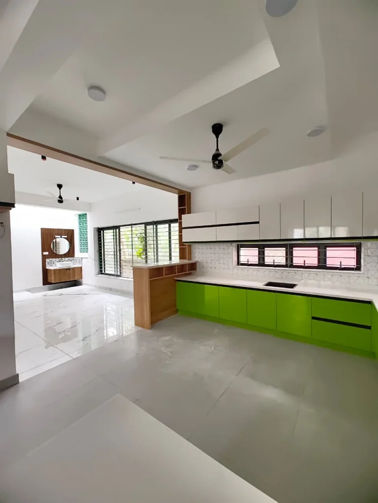 Wide view of a lime green and white modular kitchen with a timber-clad counter