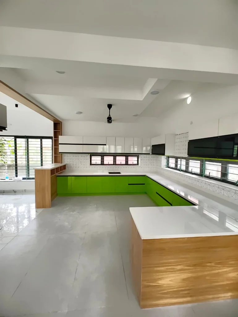 Lime green L-shaped kitchen with an oak and white island on marble flooring