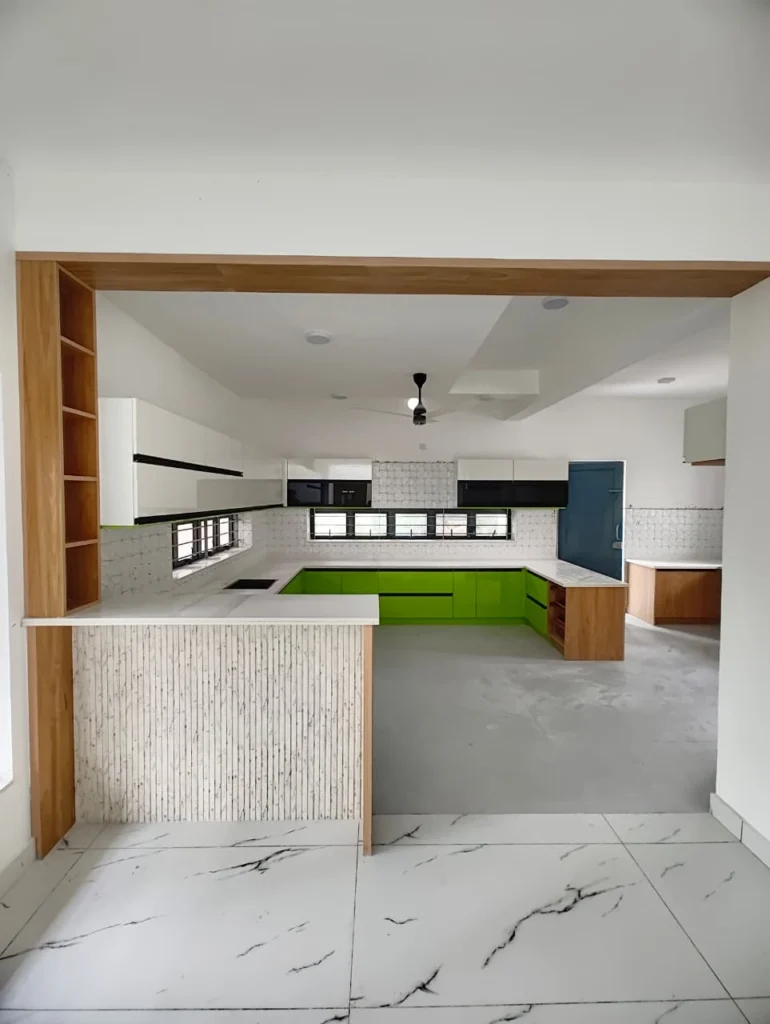 Kitchen entrance with an oak frame and textured stone counter looking onto green cabinets
