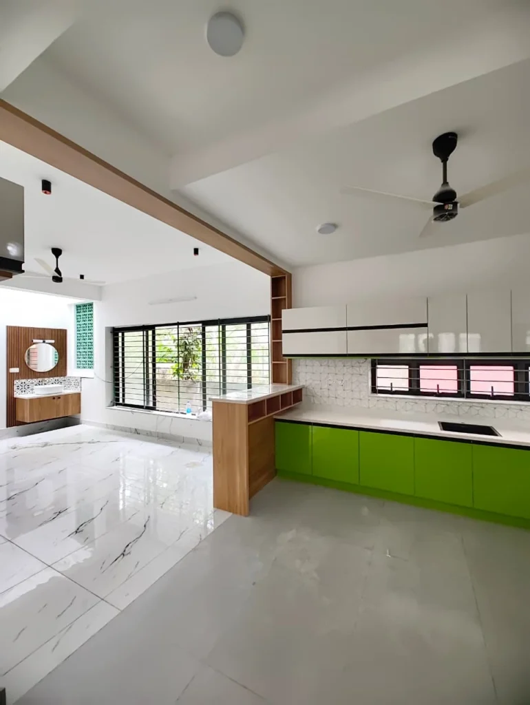 Lime green modular kitchen with white worktops beside a bright open-plan living space