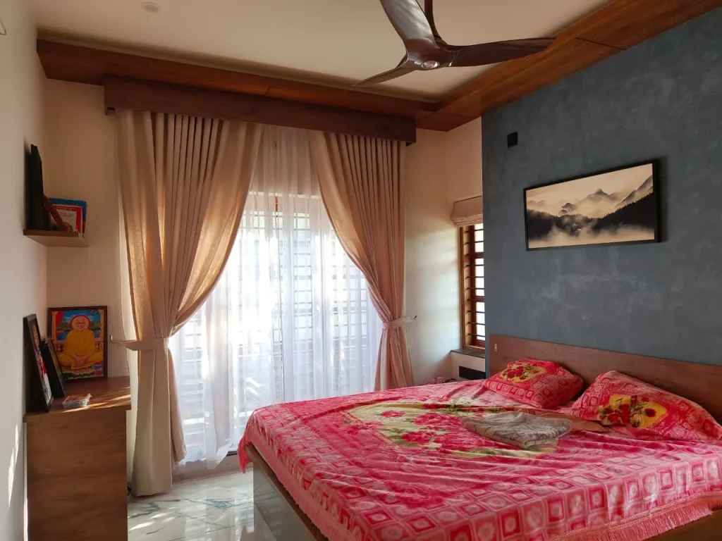 Bedroom with a blue textured feature wall, timber pelmet and linen curtains