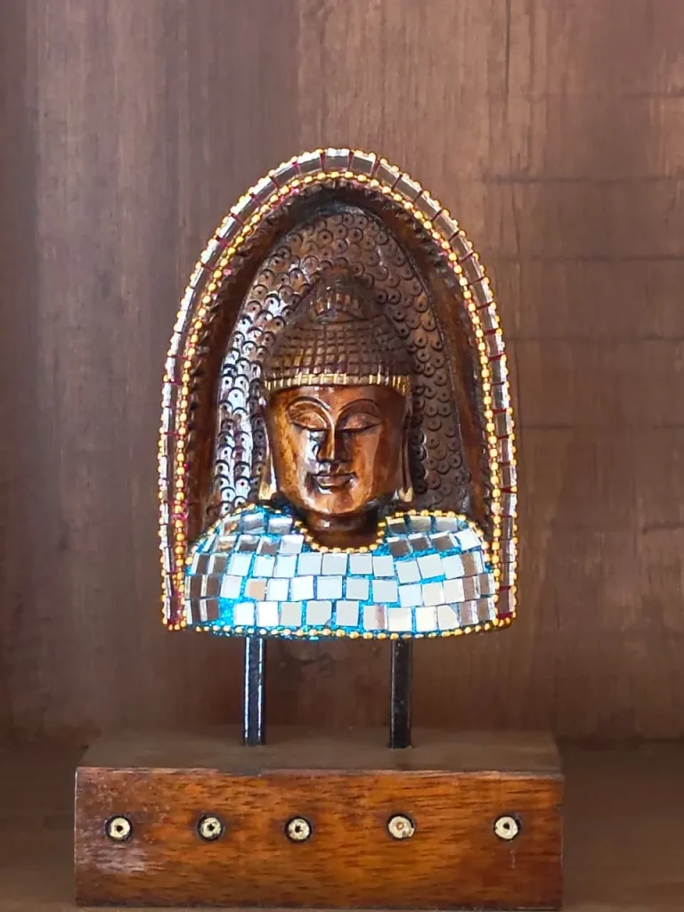 Carved wooden Buddha head with mirror mosaic on a timber stand