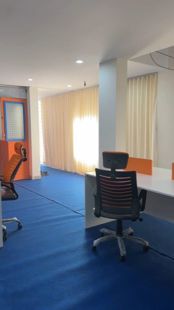 Office interior with workstations and full-height curtains