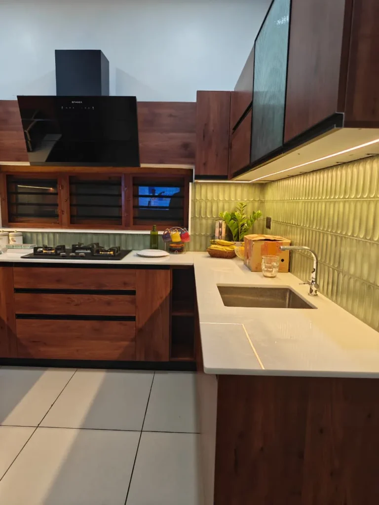 Walnut kitchen counter with an undermount sink, hob and angled chimney hood